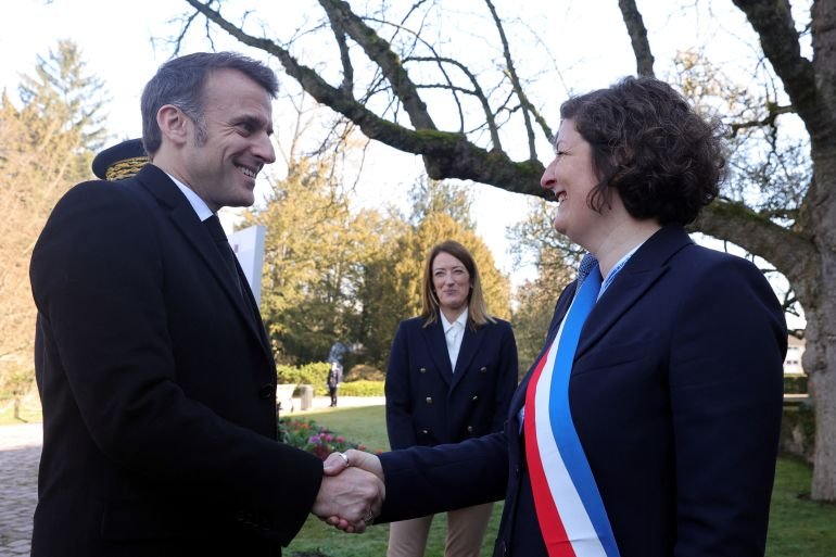 French President Emmanuel Macron shakes hands with Strasbourg's Mayor Jeanne Barseghian as they participate in a ceremony marking the 21st European Remembrance Day for Victims of Terrorism in Strasbourg, France, 11 March 2025. TERESA SUAREZ/Pool via REUTERS