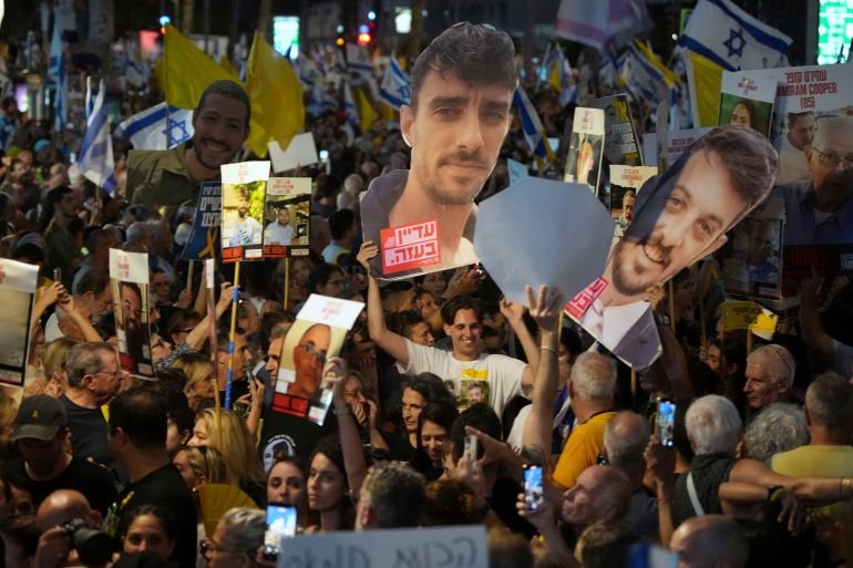 Demonstrators gather during a protest demanding the immediate release of hostages held by Hamas and calling for the Israeli government to reverse its decision to take over Gaza City and other areas in the Gaza Strip, in Tel Aviv, Israel, Sunday, Aug. 17, 2025. (AP Photo/Ohad Zwigenberg)