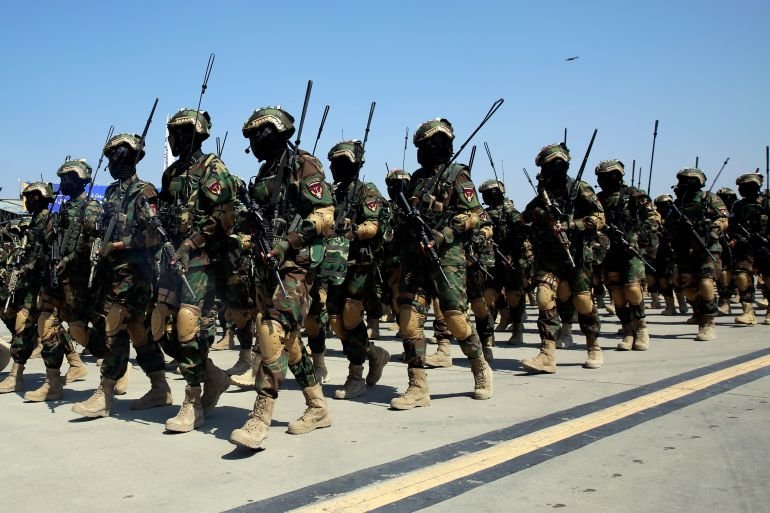 Taliban security personnel march during a military parade to mark the third anniversary of the withdrawal of U.S.-led troops from Afghanistan, in Bagram Air Base in the Parwan Province of Afghanistan, Wednesday, Aug. 14, 2024. (AP Photo/Siddiqullah Alizai)