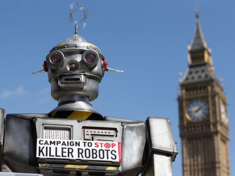 LONDON, ENGLAND - APRIL 23: A robot distributes promotional literature calling for a ban on fully autonomous weapons in Parliament Square on April 23, 2013 in London, England. The 'Campaign to Stop Killer Robots' is calling for a pre-emptive ban on lethal robot weapons that could attack targets without human intervention. (Photo by Oli Scarff/Getty Images)