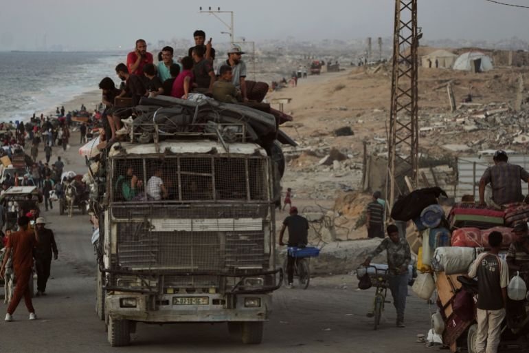 Displaced Palestinians flee Gaza City carrying their belongings along the coastal road toward southern Gaza, Wednesday, Sept. 17, 2025. (AP Photo/Abdel Kareem Hana)
