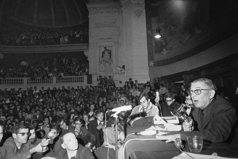 French Philosopher Jean-Paul Sartre, right, addresses Rebellious University students packed into the Sorbonne amphitheater in Paris, France, May 20, 1968. France is nearly paralyzed by a strike spread by a student-worker coalition. (AP Photo)