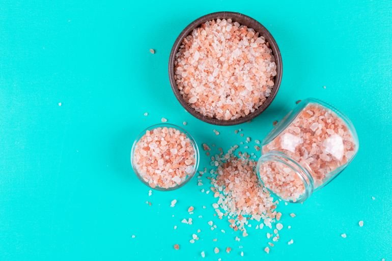 Some himalayan salt in a bowls and small jar فري بيك