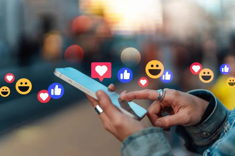 Close-up of female hand touching screen, giving likes and commenting on social media platform with smartphone. Lifestyle and technology.