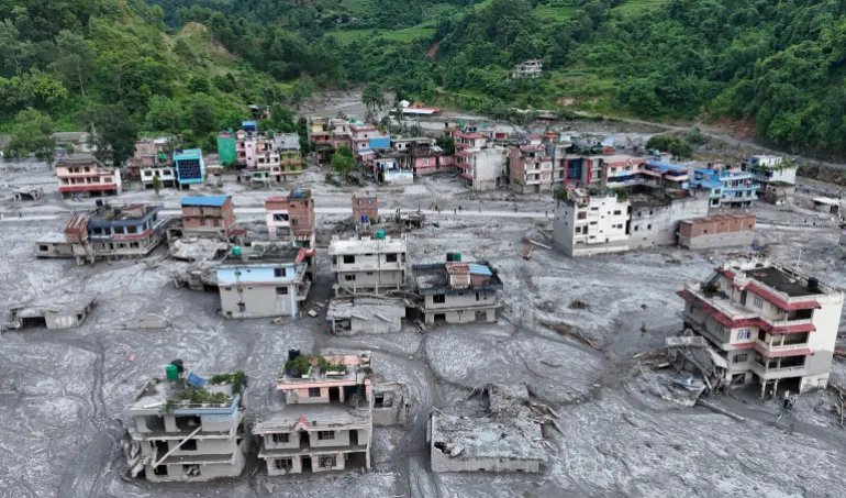 NUWAKOT, NEPAL - AUGUST 28: An Aerial view shows debris and mud covering settlements following flash floods on August 28, 2026 in DevGhat village, Nepal. Authorities said the flash floods were triggered after a mass of ice, mud and rock collapsed into a Himalayan river near the Nepal-China border, leaving hundreds dead or missing and causing widespread damage in affected districts. Authorities continued the gruelling search for victims, many buried under metres of mud, as both China and Nepal issued fresh flooding alerts. (Photo by Ritesh Shukla/Getty Images)