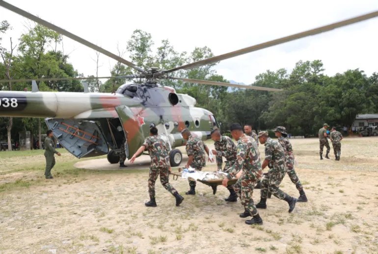 epa13193702 A handout photo made available by the Nepal Army shows army officers conducting a helicopter rescue of survivors following a flash flood in Trishuli Bazar, Nuwakot district, Nepal, 26 August 2026 (issued 27 August 2026). More than 150 people have died and hundreds remain missing across northern Nepal after a suspected avalanche triggered massive flash floods and mudslides along the Bhotekoshi and Trishuli river near the Nepal-Tibet border, causing widespread destruction to settlements and infrastructure, according to local authorities. EPA/NEPAL ARMY / HANDOUT HANDOUT EDITORIAL USE ONLY/NO SALES
