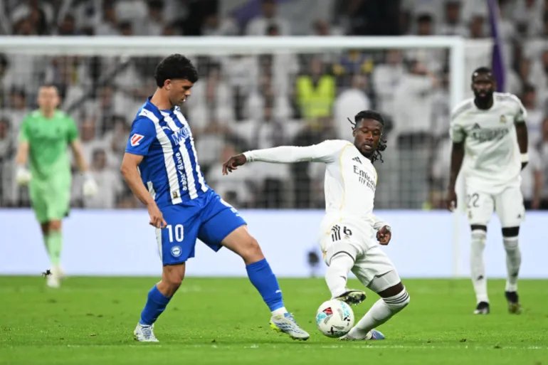 MADRID, SPAIN - APRIL 21: Carles Alena of Deportivo Alaves is tackled by Eduardo Camavinga of Real Madrid during the LaLiga EA Sports match between Real Madrid CF and Deportivo Alaves at Estadio Santiago Bernabeu on April 21, 2026 in Madrid, Spain. (Photo by Denis Doyle/Getty Images)