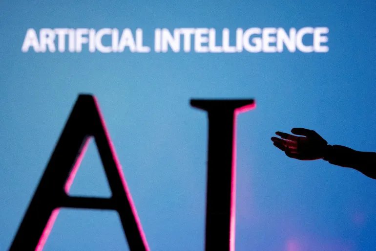 FILE PHOTO: AI (Artificial Intelligence) letters and robot hand miniature in this illustration taken, June 23, 2023. REUTERS/Dado Ruvic/Illustration/File Photo