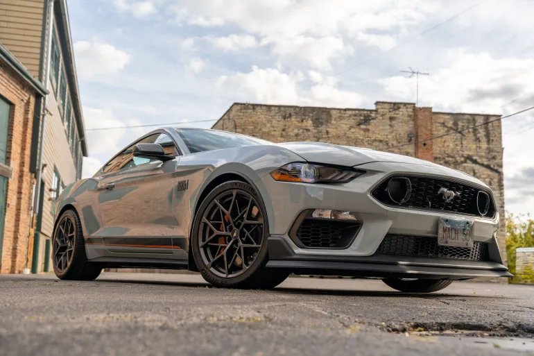 A sleek Ford Mustang parked in an urban area of Illinois. Perfect for automotive enthusiasts.