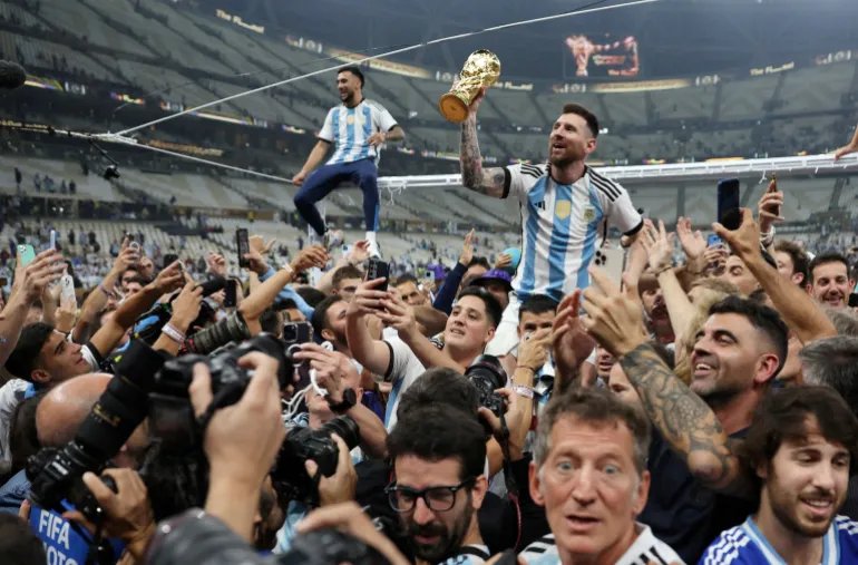 FILE PHOTO: Soccer Football - FIFA World Cup Qatar 2022 - Final - Argentina v France - Lusail Stadium, Lusail, Qatar - December 18, 2022 Argentina's Lionel Messi celebrates with the trophy after winning the World Cup REUTERS/Carl Recine/File Photo