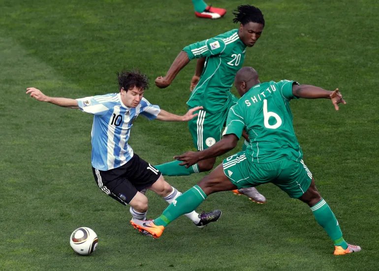 FILE - Argentina's Lionel Messi, left, competes for the ball with Nigeria's Danny Shittu, right, and Nigeria's Dickson Etuhu, center, during the World Cup group B soccer match in Johannesburg, South Africa, June 12, 2010. (AP Photo/Hassan Ammar, File)