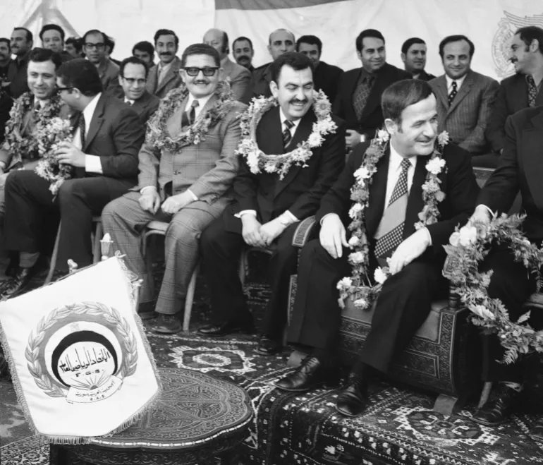 Syrian President Hafez Assad is pictured during the dedication ceremony at Sports Stadium in Damascus, March 8, 1974. This is the 8th anniversary of the Baath Party takeover of power in Syria. Assad is flanked by top party aids, all wearing garlands. (AP Photo/Azad)