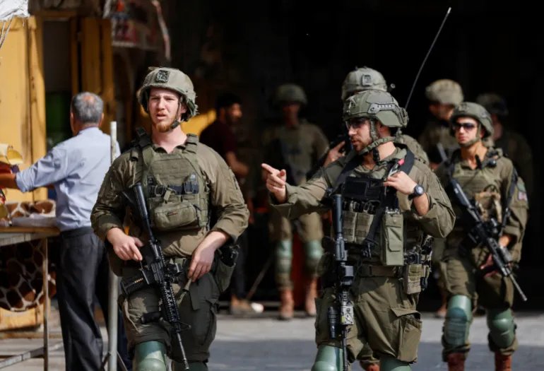 Israeli soldiers patrol the area as they keep watch on the day of Israeli settlers' weekly tour in Hebron, in the Israeli-occupied West Bank, August 29, 2026. REUTERS/Mussa Qawasma
