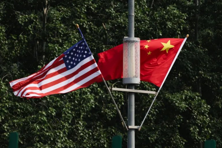 BEIJING, CHINA - MAY 13: The national flags of the United States and China hang on airport highway on May 13, 2026 in Beijing, China. President Donald Trump will arrive in Beijing on May 13th for a two day summit with Chinese President Xi Jinping. It will be the first visit to China by a U.S. President since Trump's last visit in 2017. (Photo by Lintao Zhang/Getty Images)