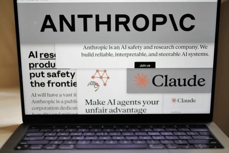 FILE - Pages from the Anthropic website and the company's logos are displayed on a computer screen in New York, Feb. 26, 2026. (AP Photo/Patrick Sison, File)