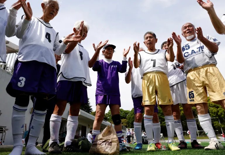 White Bear’s goalkeeper Shingo Shiozawa (center), 93, claps with his teammates following the Japanese custom 'temije' (a ceremonial rhythmic hand clapping), after the SFL (Soccer For Life) 80 League opening match in Tokyo, Japan, April 12, 2023. Shiozawa trains several times a month and the sport has motivated him to quit smoking due to the intensive running it requires and has also helped him recover swiftly after being treated for spinal stenosis. "If I hadn't played soccer, I'd have been dead already," he said. REUTERS/Kim Kyung-Hoon SEARCH "HOON SOCCER" FOR THIS STORY. SEARCH "WIDER IMAGE" FOR ALL STORIES.