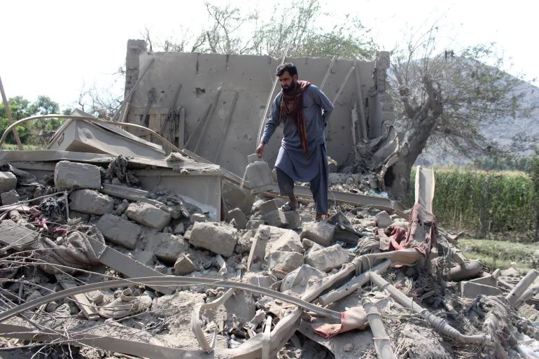 A man retrieves belongings from the debris of a house that was damaged in what the Taliban said was a Pakistani airstrike in Kunar province, Afghanistan, September 21, 2026. REUTERS/Stringer
