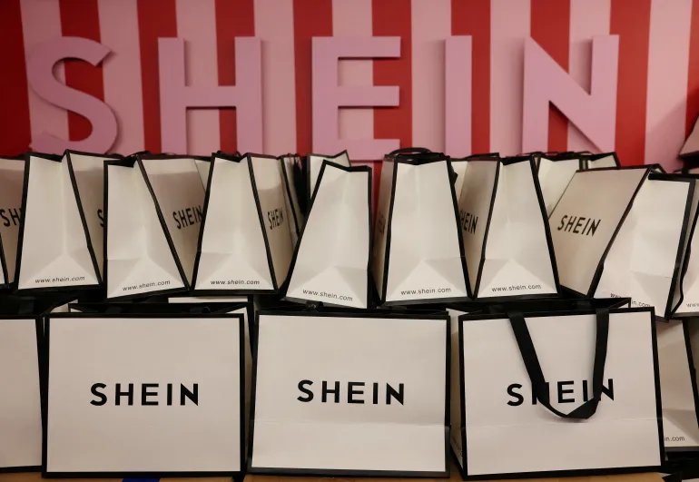 FILE PHOTO: A company logo for fashion brand Shein is seen on a pile of gift bags on its Christmas bus as part of a nationwide promotional tour in Liverpool, Britain, December 14, 2024. REUTERS/Phil Noble/File Photo