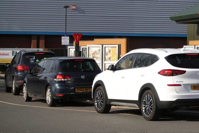 Cars queue up at a drive thru McDonald's restaurant, as the spread of the coronavirus disease (COVID-19) continues, Newcastle-under-Lyme, Britain, March 23, 2020. REUTERS/Carl Recine