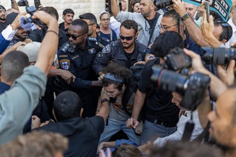 Policemen scuffle with Israeli left-wing protesters to make way for the far-right National Security Minister Itamar Ben Gvir outside the Supreme Court in Jerusalem on October 1, 2026.