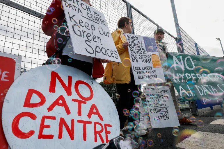 KILMARNOCK, SCOTLAND - SEPTEMBER 30: Community campaigners demonstrating against a proposed large-scale data centre rally outside the Park Hotel, where a B2B event attended by representatives from Eneus Energy is taking place on September 30, 2026 in Kilmarnock, Scotland. Demonstrators from the Reject Hunterston Data Centre Campaign Group and the Hurlford Rufus Data Centre Group are protesting Eneus Energy's proposal to build a large-scale data centre campus in Hunterston, North Ayrshire, raising concerns over the development's potential impact on the local environment and resources. (Photo by Jeff J Mitchell/Getty Images)