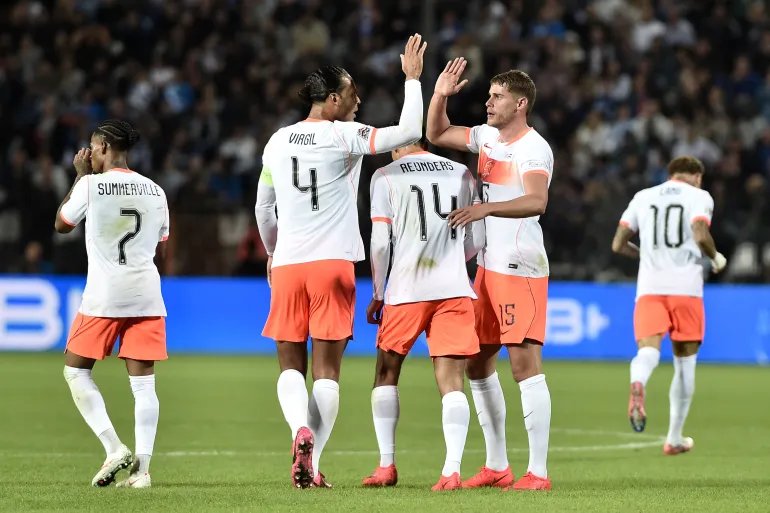 Netherlands' defender #04 Virgil van Dijk (2L) and Netherlands' defender #15 Micky van de Ven (R) high five each other as The Netherlands' players celebrate scoring a goal during the UEFA Nations League Group A2 football match between Greece and The Netherlands at the Toumba Stadium in Thessaloniki on October 1, 2026.
