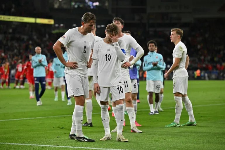 Norway's midfielder Martin Odegaard and Norway's midfielder Sander Berge (L) react following the UEFA Nations League, league A, group 4 football match between Wales and Norway, at the Cardiff City Stadium, in Cardiff, on October 1, 2026.