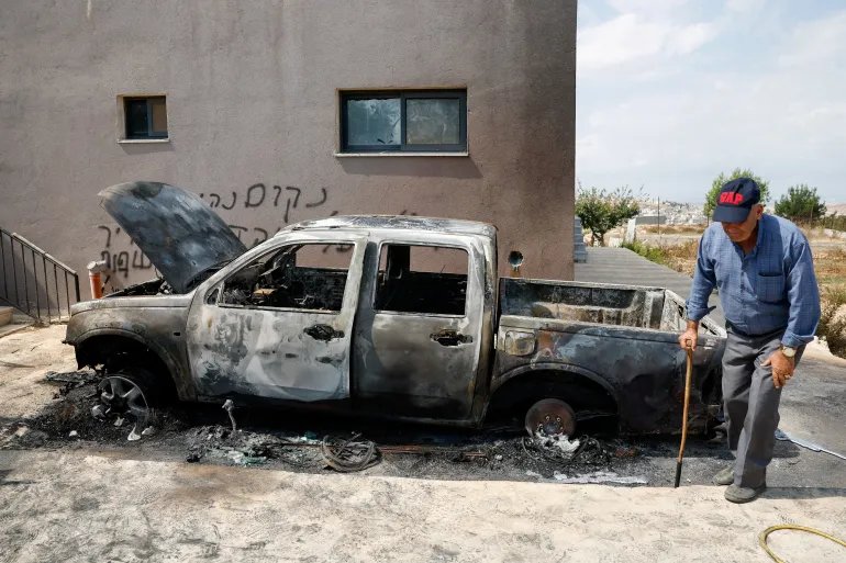 A Palestinian man walks next to a vehicle damaged in what Palestinians say was an Israeli settlers attack, in Deir Abu Masha'al, near Ramallah, in the Israeli-occupied West Bank, September 28, 2026. REUTERS/Mohamad Torokman TPX IMAGES OF THE DAY