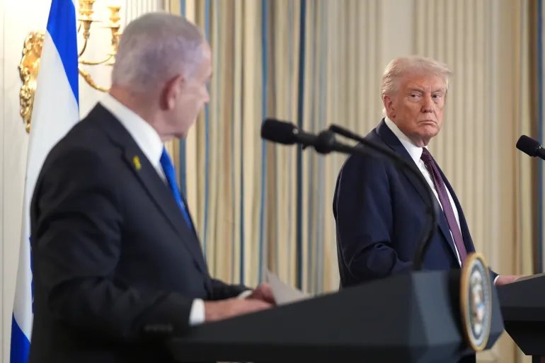 FILE - President Donald Trump, right, listens during a news conference with Israeli Prime Minister Benjamin Netanyahu in the State Dining Room of the White House, Sept. 29, 2025, in Washington. (AP Photo/Evan Vucci, File)