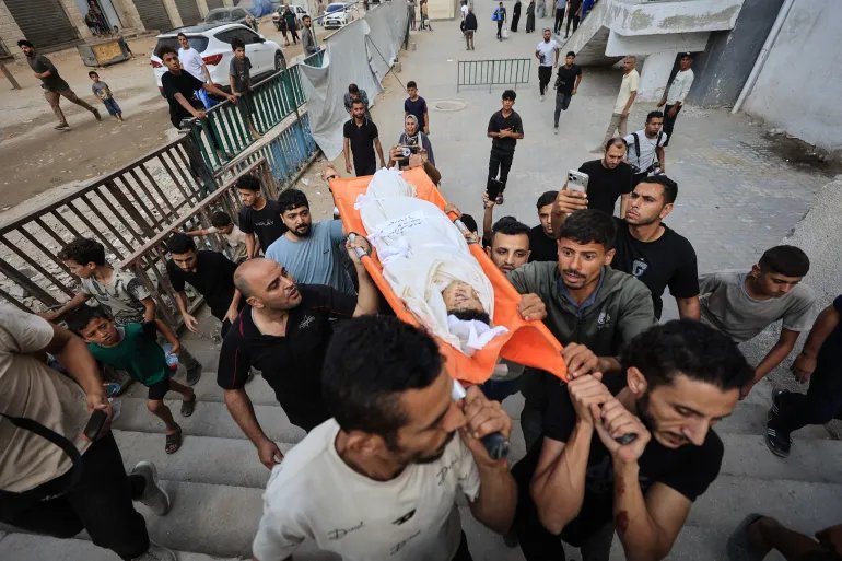 EDITORS NOTE: Graphic content / Mourners carry the body of Hussam Hawso, an 8-year-old Palestinian boy who was reportedly killed in an Israeli strike on residential buildings in the Sabra neighbourhood the previous night, during his funeral at Al-Shifa Hospital in Gaza City on October 9, 2026.