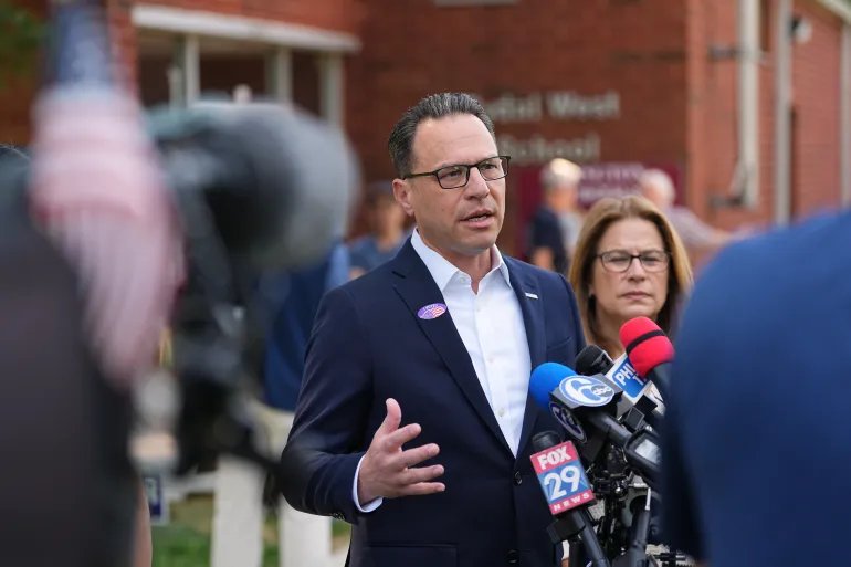 Pennsylvania Gov. Josh Shapiro, accompanied by his wife Lori Shapiro, speaks with members of the media outside his polling place in Rydal, Pa., Tuesday, May 19, 2026. (AP Photo/Matt Rourke)