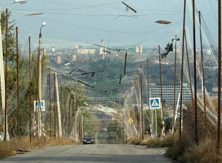 A car rides on a road covered with anti-drone nets, amid Russia's attack on Ukraine, in the frontline city of Kramatorsk, Ukraine October 14, 2026. Picture taken with a mobile phone. REUTERS/Stringer