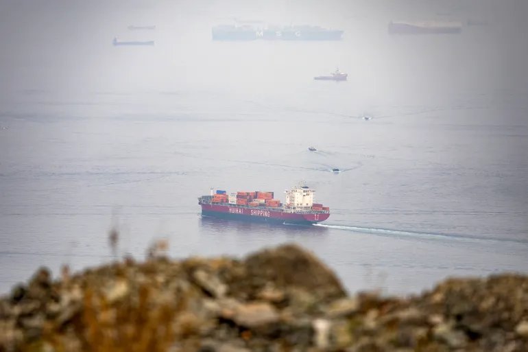 The Chinese-flagged container shipping vessel Hui Fa transits the Gulf of Oman off the coast of Khor Fakkan in the emirate of Sharjah in the east of the UAE on October 13, 2026.