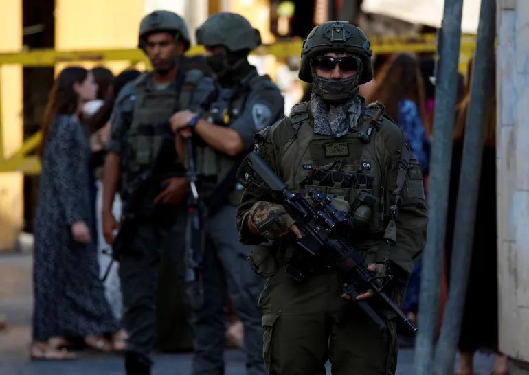 Israeli forces keep watch during Israeli settlers' weekly tour in Hebron, in the Israeli-occupied West Bank, September 19, 2026. REUTERS/Mussa Qawasma